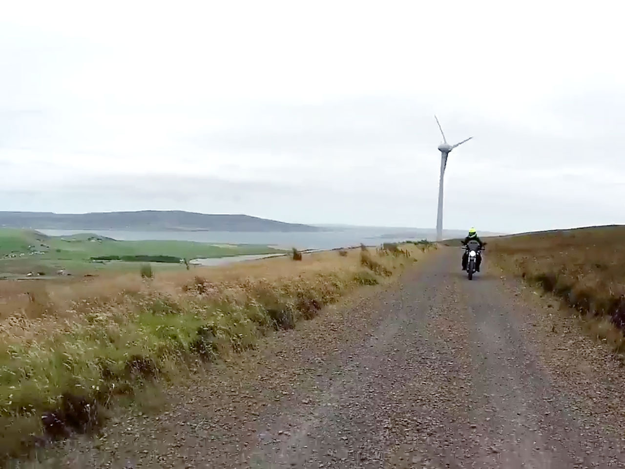 John Chivers and his Zero DSR electric motorcycle at Hammars Hill wind farm on Orkney.